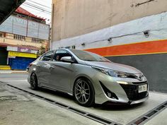 a silver car parked in front of a building