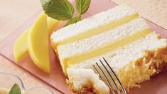 a piece of cake sitting on top of a pink plate next to a knife and fork