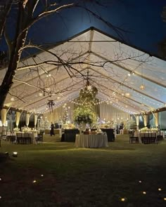 a large tent with tables and chairs under it