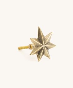 a gold ring with a star design on the front and back of it, against a white background