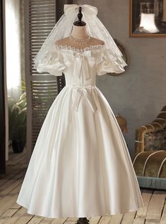 Discover the essence of classic bridal beauty in this exquisite wedding dress, where every detail echoes a love for the traditional! Dance through your day in a gown that features a sweetheart neckline, framed by lace that whispers of vintage charm. The bodice, cinched at the waist with a satin bow, creates a silhouette thatboth flattering and reminiscent of an era when romance reigned supreme. The skirt cascades in a sweep of satin, perfect for gliding down the aisle. This gown is a tribute to timeless love, an heirloom-in-waiting that will leave a legacy of beauty and grace. Prom Dress White, Evening Dress Wedding, Off Shoulder Wedding Dress, Bow Wedding Dress, White Evening Dress, Waist Jacket, White Prom Dress, Tea Length Wedding Dress, Short Prom Dress