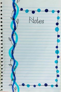 an open notebook with writing on it and blue spirals in the paper that says notes