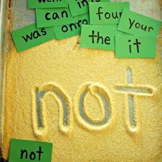 sand with words written on it and green sticky notes attached to the bottom that read not