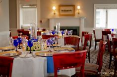 a dining room with red, white and blue tables set for an elegant dinner party