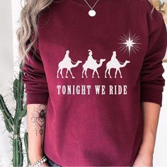 PORTION OF ALL PROCEEDS ARE DONATED TO CHARITY! GRAB ONE TODAY! Embrace the spirit of Christmas with our "Tonight We Ride" Christian Sweatshirt. This cozy sweater is not just clothing; it's a festive celebration of faith and the Christmas story. Featuring a Three Wise Men design, it's the perfect Christian gift and a stylish way to share the joy of the season. Spread the message of faith and joy with this special Christmas sweater--a unique addition to your holiday wardrobe. 🌟👕 #ChristianChris Tonight We Ride Christmas, Roi Mage, Three Wise Men, Three Kings, Christian Sweatshirt, Wise Men, Christian Christmas, Christian Shirt, Holiday Wardrobe