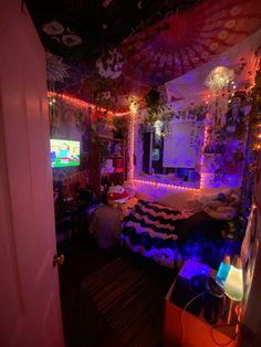 a bedroom decorated for halloween with lights and decorations on the walls, bedding and rugs