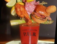 a tall glass filled with food sitting on top of a table next to a menu