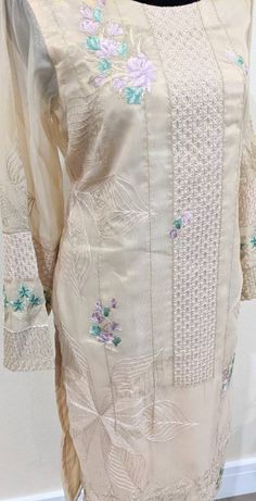 Beige color kurta with full embroidered front panel along with hint of green and purple bunches on sleeves and daman. Additional information - Fabric is banarsi Size Small Elegant Straight Kurta With Multicolor Embroidery, Elegant Salwar Kameez With Multicolor Embroidery, Elegant Long Sleeve Traditional Wear With Multicolor Embroidery, Pista Green Embroidered Long Sleeve Churidar, Embroidered Pista Green Long Sleeve Churidar, Embroidered Long Sleeve Pista Green Churidar, Long Sleeve Cotton Silk Kurta With Intricate Embroidery, Beige Chanderi Kurta With Floral Embroidery, Traditional Cotton Silk Unstitched Suit For Spring