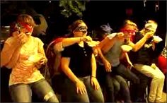 a group of people sitting next to each other with masks on their faces and mouths