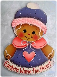 a ginger's warm the heart ornament with a teddy bear wearing a blue dress and pink hat