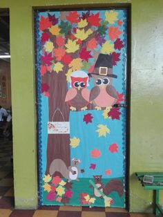 a door decorated with fall leaves and owls