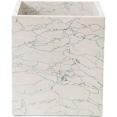 a white marble box with black lines on the inside and bottom, sitting in front of a white background