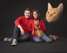 a man and woman sitting next to a cat on a black background with an orange cat