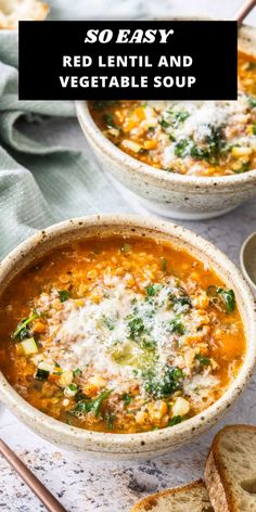 two bowls of red lentil and vegetable soup on a white table with bread in the background