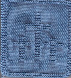 a blue crocheted dishcloth with squares on it