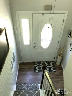 an entryway with a door and rug on the floor next to it is shown from above