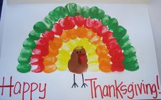 a handmade turkey card with the words happy thanksgiving written in red, green and orange