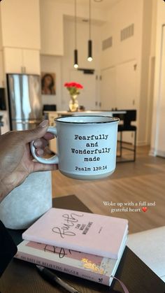 a person holding up a coffee mug with the words, beautifully wonderful made written on it