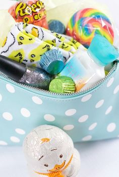 a blue polka dot bag filled with lots of candy