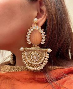 Beautiful and unique 22k antique gold plated chaandbali with carved peach onyx stones and  pearls hanging  *Lightweight also comes with complimentary Saharas Height = 3.5 inches Classic Earring Antique Earring Customized orders takes 3 to 4 weeks, depending on piece requirements. The Ombre Designs Jewelry pieces can be customized in accordance with your requirement. Please Email or Whats app on : +91 8448833193 / sonalikamehra [!at] theombredesigns.com Bohemian Chandbali Jhumkas With Stone Work, Festive Bohemian Chandbalis With Stone Work, Bohemian Chandbali Earrings With Stone Work, Bohemian Kundan Chandbalis With Stone Work, Chandbalis With Stone Work For Navratri, Stone Work Chandbalis For Navratri, Navratri Chandbalis With Stone Work, Bohemian Kundan Danglers With Stone Work, Bohemian Chandbali Bridal Earrings With Stone Work