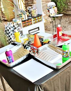 the table is set up with plates and other items for an outdoor party or event