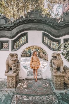 a woman standing in front of an archway