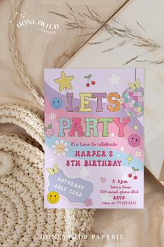 a birthday party card sitting on top of a table next to a wicker basket