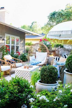 an outdoor patio with chairs and potted plants