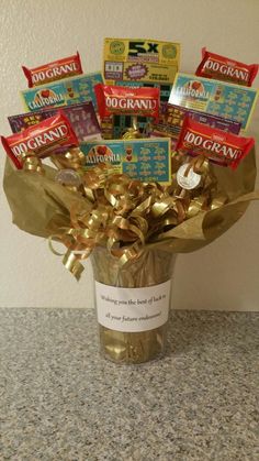 a vase filled with lots of candy and candies on top of a granite counter