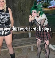 two women with green hair are standing next to each other and one has her hand on her mouth