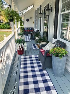 the front porch is decorated with blue and white checkered rugs