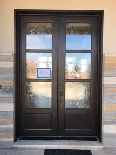 a black door with two glass panels on it