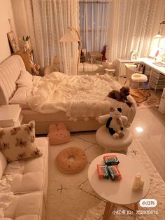 a bedroom with white furniture and teddy bears on the floor in front of the bed