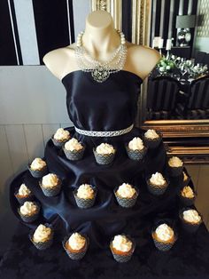 a dress made out of cupcakes on top of a table