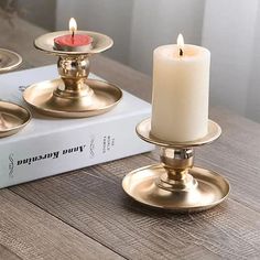 three candles are sitting on top of a book