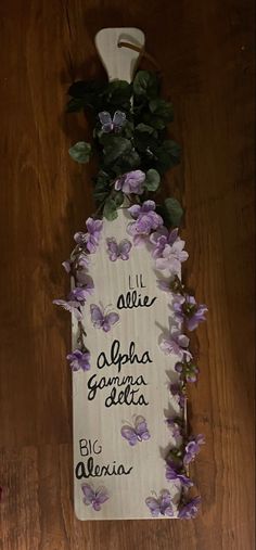 a wooden sign with purple flowers on it that says, i'll alice aloha gariga delta