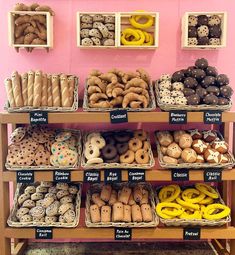 a display case filled with lots of different types of doughnuts and pretzels