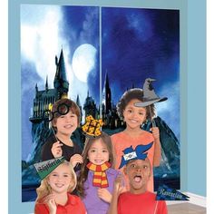 three children are posing for a photo in front of a backdrop with hogwart's castle