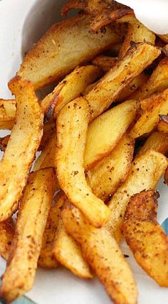 some french fries on a plate with seasoning