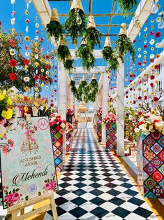 a walkway decorated with flowers and hanging decorations