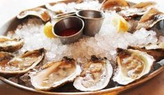 an assortment of oysters are served on a platter