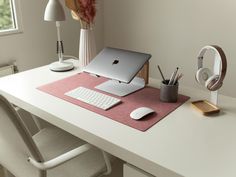 an apple computer sitting on top of a white desk