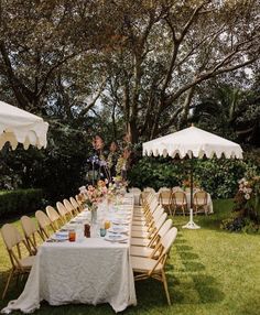 an outdoor dining area with tables and chairs set up under umbrellas for people to eat