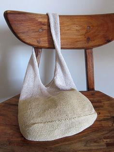 a white bag sitting on top of a wooden chair