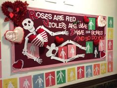 a bulletin board is decorated with skeletons and red heart shaped paper cutouts for valentine's day