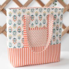 an orange and white striped bag sitting on top of a table