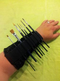 a woman's arm with multiple brushes on it