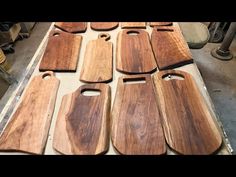 several wooden cutting boards sitting on top of a table