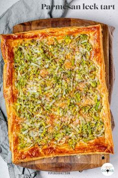 a square pizza on a wooden cutting board with text overlay that reads parmesan lee tart