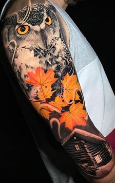 an owl and leaves tattoo on the arm